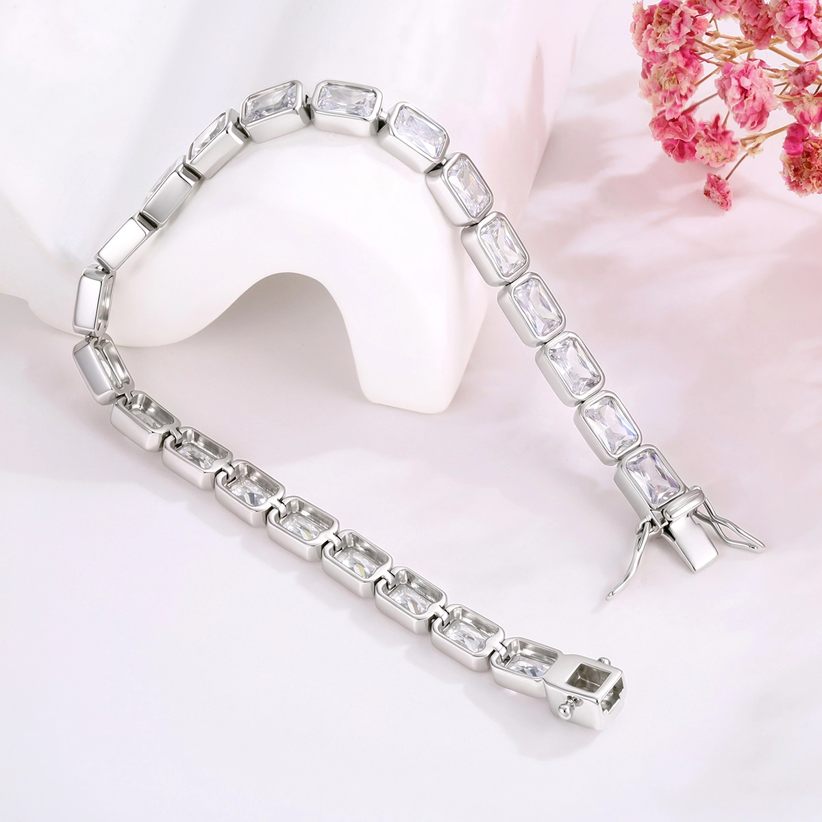 Silver CZ tennis bracelet with polished bezel settings and secure box clasp