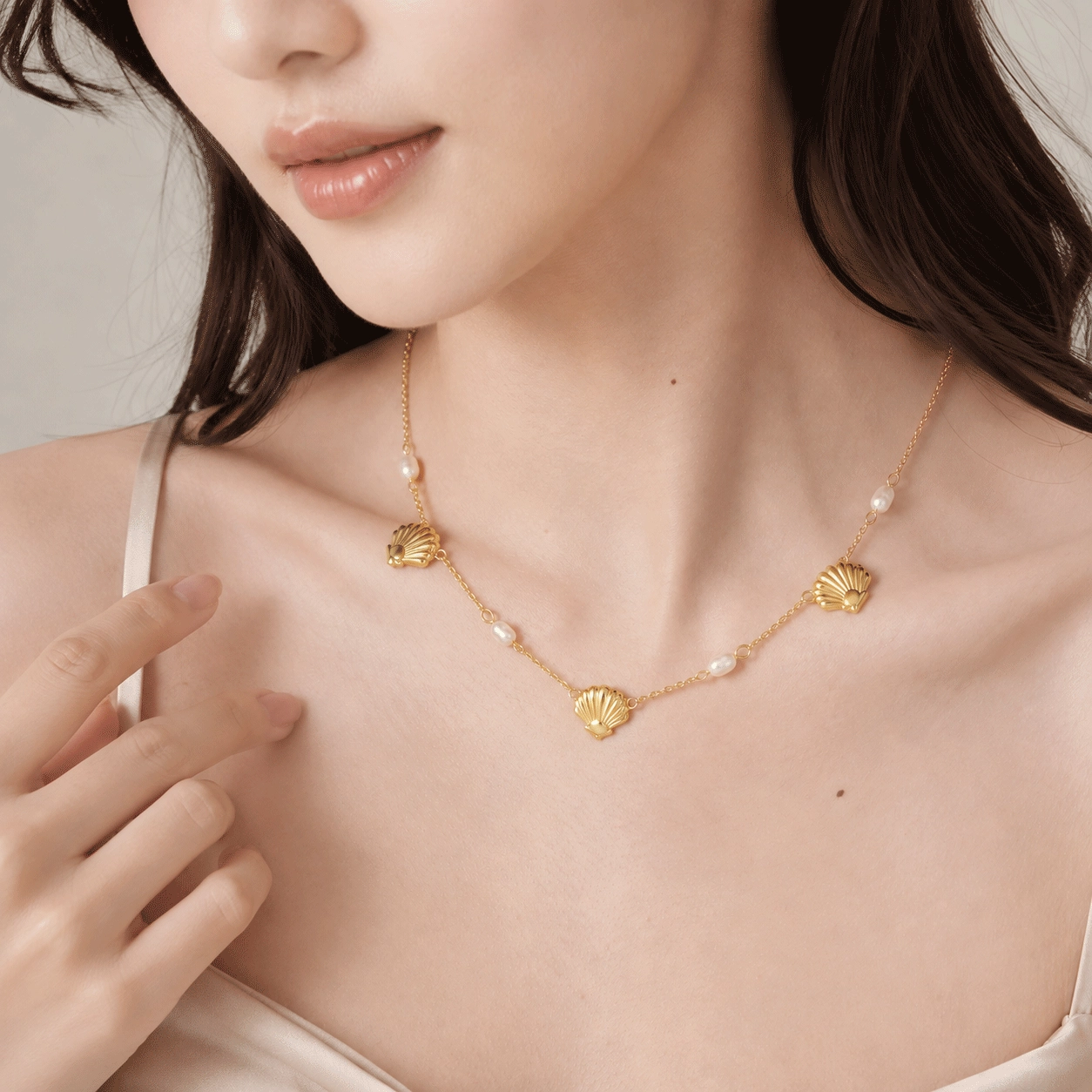 Model wearing a pearl necklace design available with a 925 sterling silver base option - Zhefan Jewelry