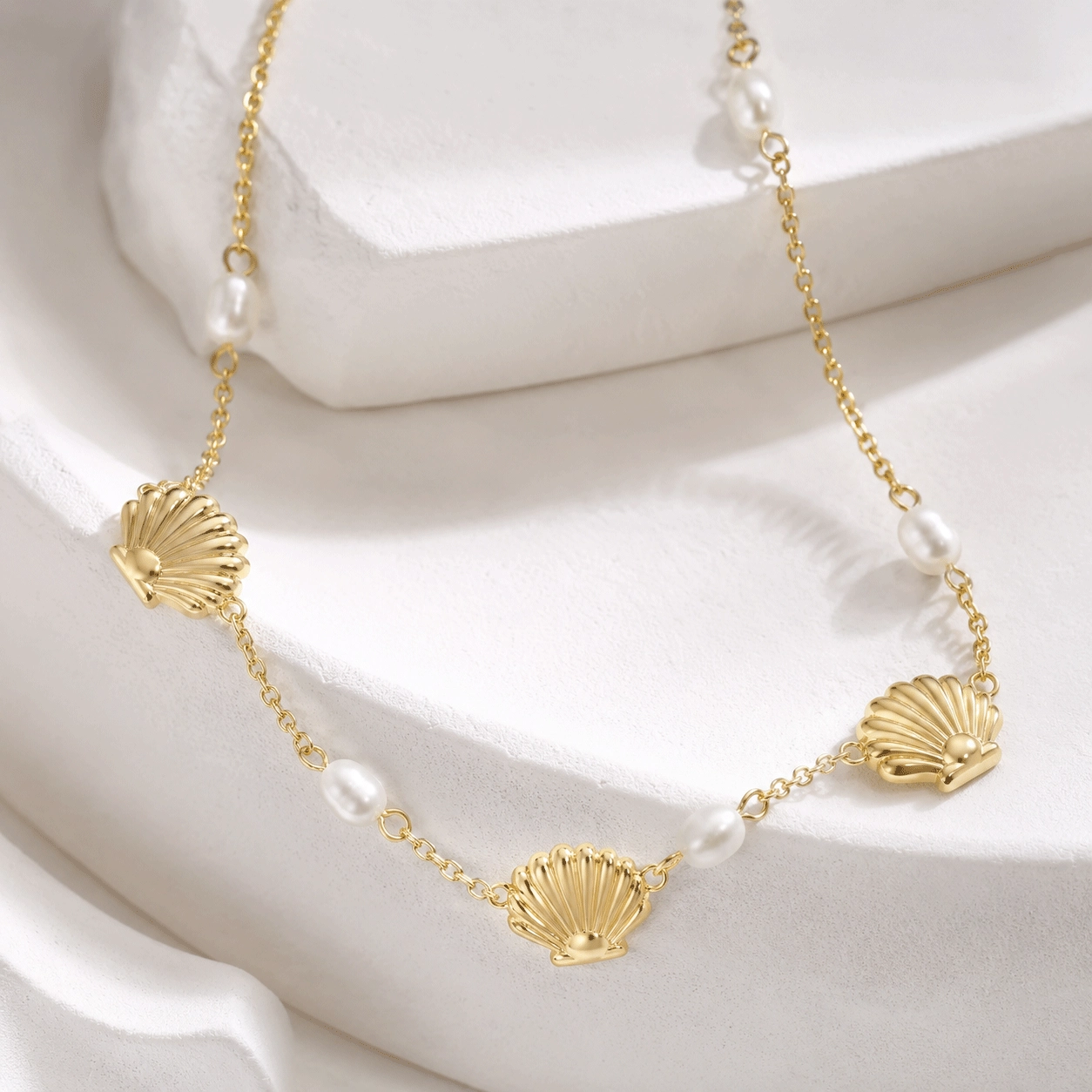Close-up detail of freshwater pearls, shell elements and gold tone chain construction - Zhefan Jewelry