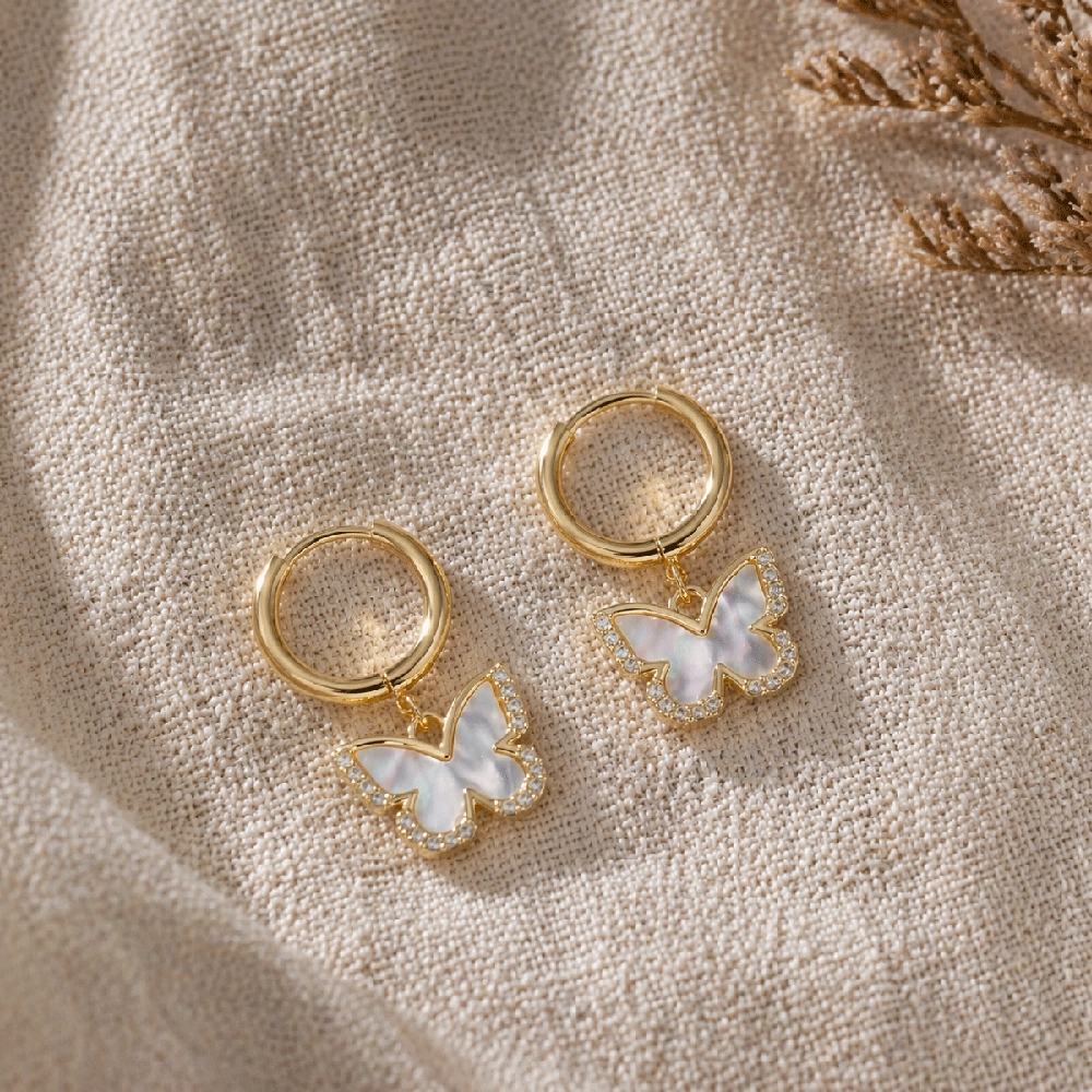 Gold hoop earrings with butterfly charm